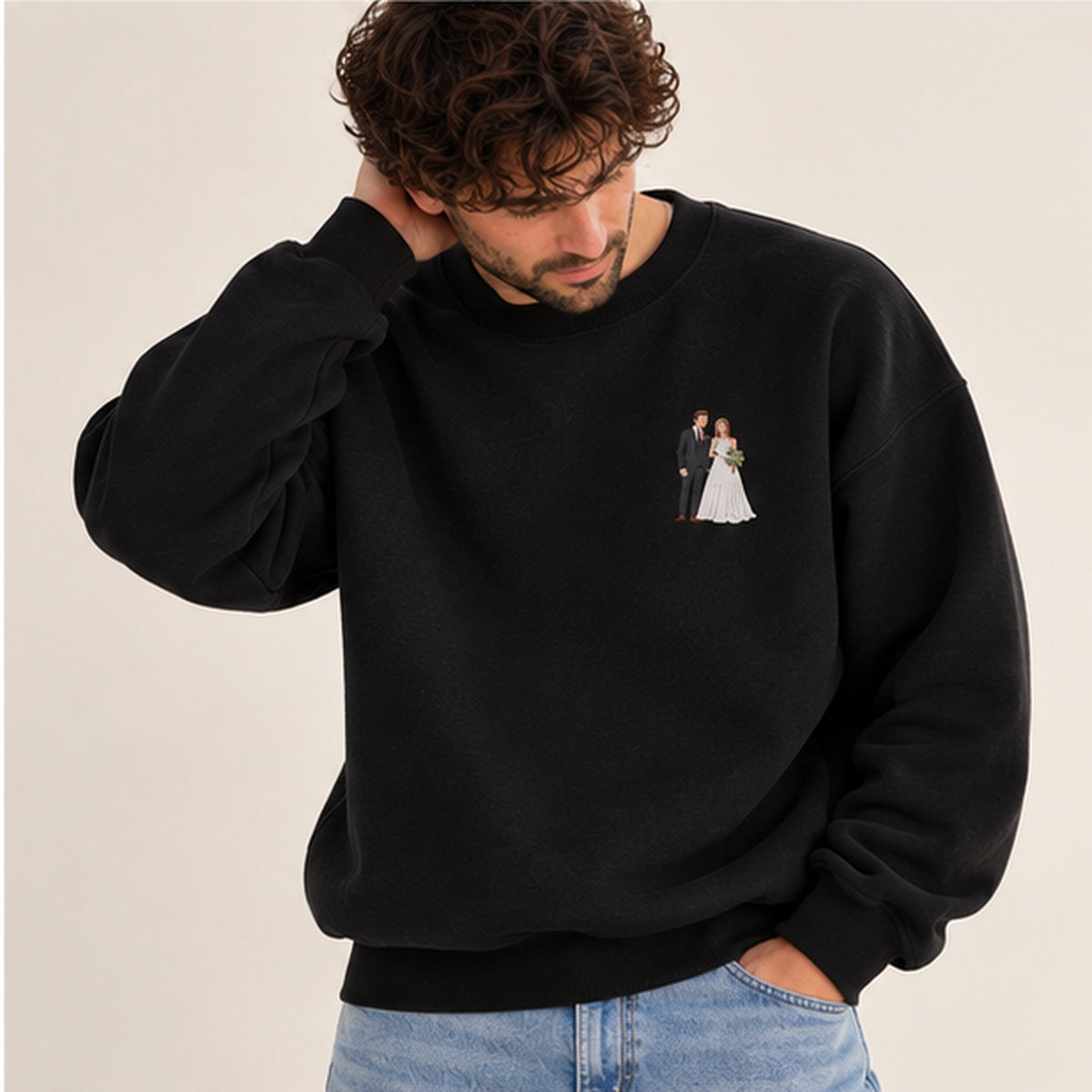 Man modelling a jet black heavyweight embroidered photo sweater with a small bride and groom wedding design