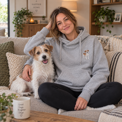 Woman wearing a personalised embroidered dog portrait cross neck hoodie with her pet in a cosy home UGC photo