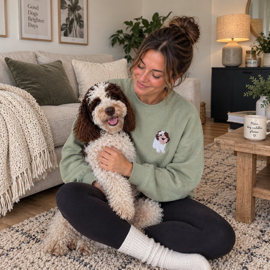 Personalised embroidered pet portrait sweater with woman cuddling her dog