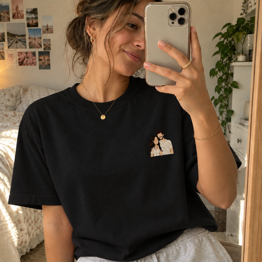 Woman wearing a black personalised embroidered photo T-shirt with a small full-colour faceless couple portrait in a natural mirror selfie