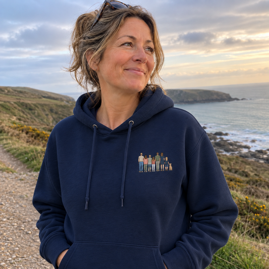Woman wearing a New French Navy personalised embroidered photo hoodie with a small full-colour family portrait on a coastal walk