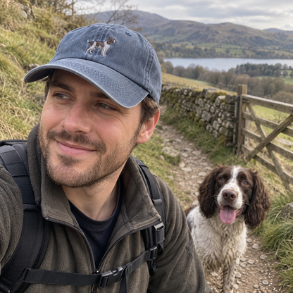 Man wearing a personalised pet portrait vintage cap in Vintage Denim with full-body spaniel embroidery on a countryside walk