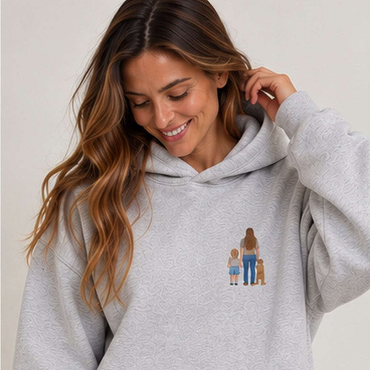 Heather grey personalised embroidered memory hoodie worn by woman, square studio photograph