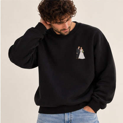 Man modelling a jet black heavyweight embroidered photo sweater with a small bride and groom wedding design