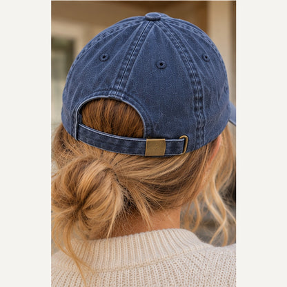 Back view of washed denim vintage cap showing adjustable strap and brass effect buckle