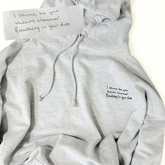 A high-quality hoodie showcasing a beautifully embroidered handwritten note. The heartfelt message is delicately stitched onto the hoodie, adding a personal touch to this unique and meaningful piece of apparel